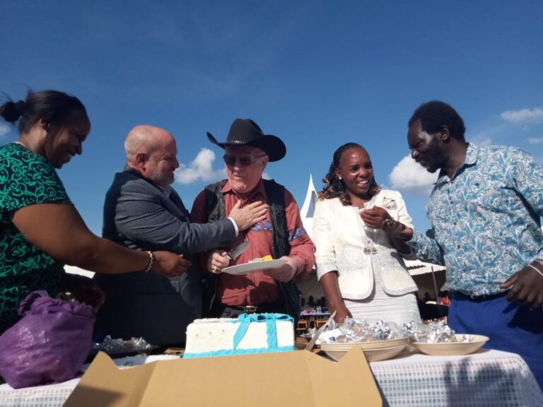 Jacinta, Patrick cut the cake with George and Dr. Tim