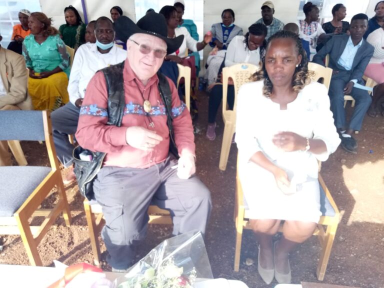 George seated together with executive director of Juanita School, Jacinta