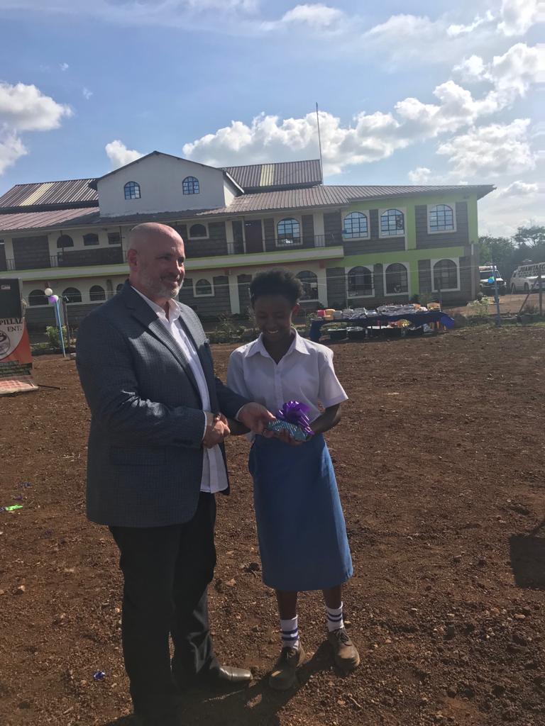 Dr. TIm hands out a gift to the most outstanding student, Mercy