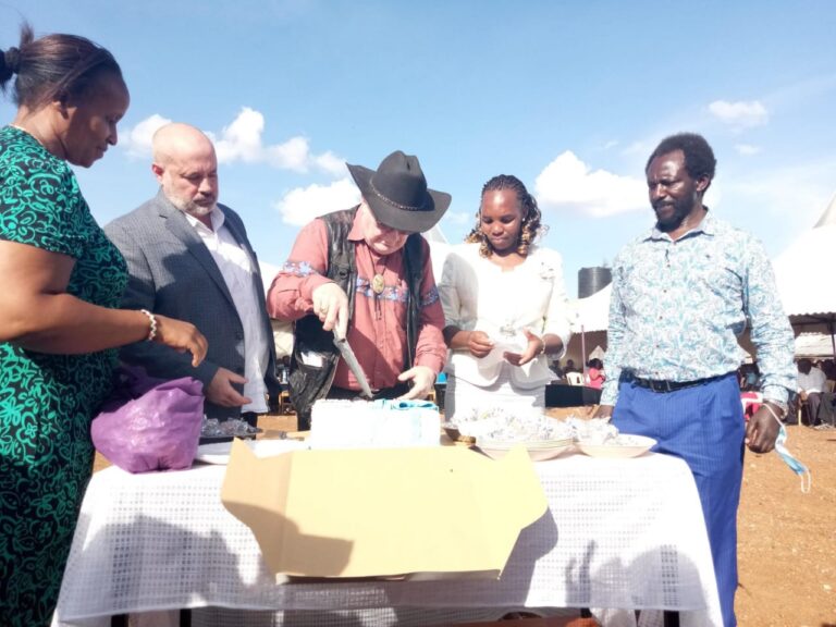 Jacinta, Patrick cut the cake with George and Dr. Tim