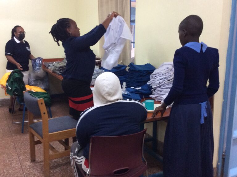 A new student receives her new Juanita School Uniform.